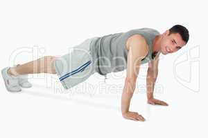 Side view of man doing push ups