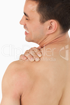 Young male experiencing neck pain