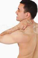 Young male suffering from neck pain