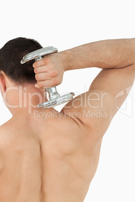 Back view of young man with dumbbell