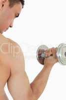 Atletic guy lifting dumbbell