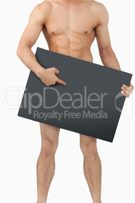 Atletic male body pointing on banner below him
