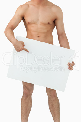 Well shaped male body pointing on banner below him