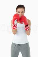 Young female boxer in defensive stance