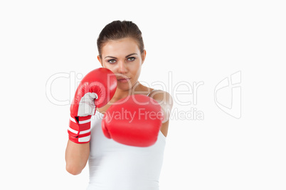 Young female boxer attacking with her left