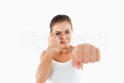 Female martial arts fighter attacking with left fist
