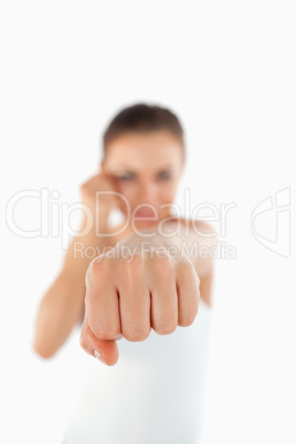 Left fist of female martial arts fighter attacking