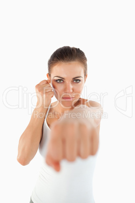 Female martial arts fighter striking with her fist
