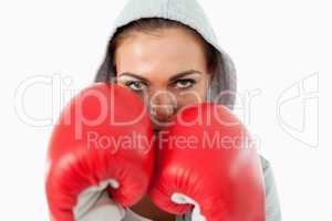 Female boxer with hoodie on taking cover