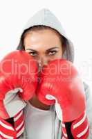 Female boxer with hoodie on in defensive stance