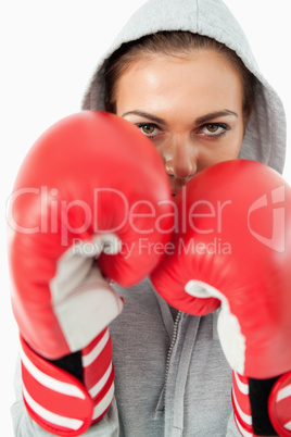 Young female boxer with hoodie on