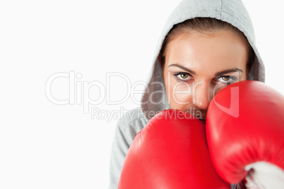 Female boxer with hoodie on in defensive position