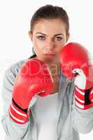 Portrait of a young woman with boxing gloves