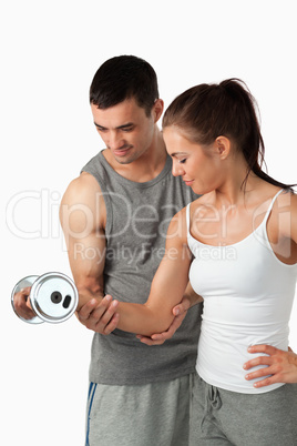 Portrait of a man helping a woman to work out