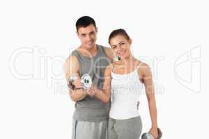 Man helping a gorgeous woman to work out
