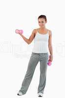 Portrait of a fit woman working out with dumbbells