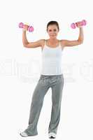 Portrait of a young woman working out with dumbbells