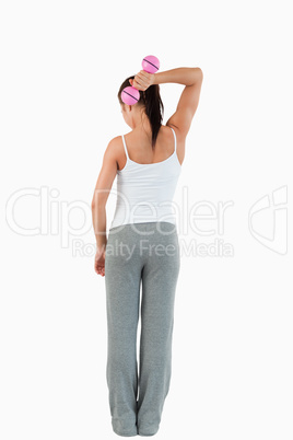Portrait of a healthy woman working out with dumbbells