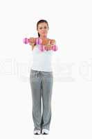 Portrait of a cute woman working out with dumbbells