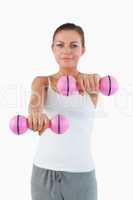 Portrait of a gorgeous woman working out with dumbbells