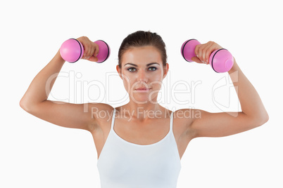 Fit woman working out with dumbbells