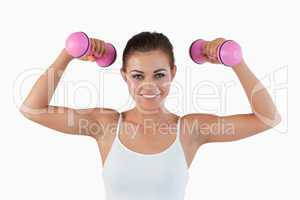 Sports woman working out with dumbbells