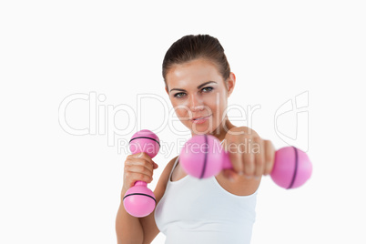 Young woman working out with dumbbells