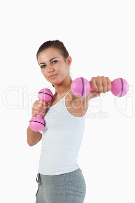 Portrait of a beautiful woman working out with dumbbells