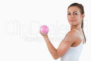 Brunette woman working out with dumbbells