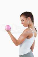 Portrait of a muscular woman working out with dumbbells