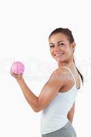 Portrait of a joyful woman working out with dumbbells