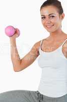 Close up of a young woman working out with dumbbells