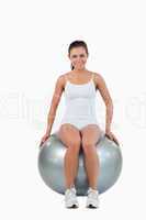 Portrait of a happy woman working out with a ball
