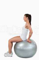 Portrait of a joyful woman working out with a ball