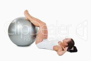 Woman developing  her abs with a ball