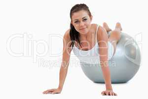 Young woman working out with a ball