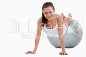 Smiling woman working out with a ball