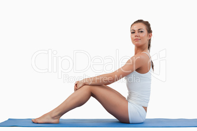 Woman sitting on a foam mat