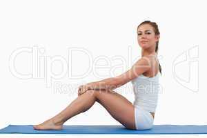 Woman sitting on a foam mat