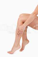 Portrait of a feminine hand touching legs