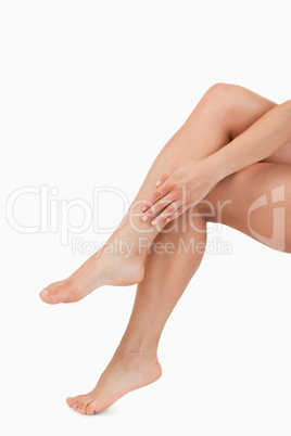 Portrait of a hand touching legs