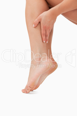 Close up of a feminine hand touching legs