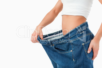 Fit woman wearing too large pants