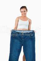 Portrait of a woman showing large jeans
