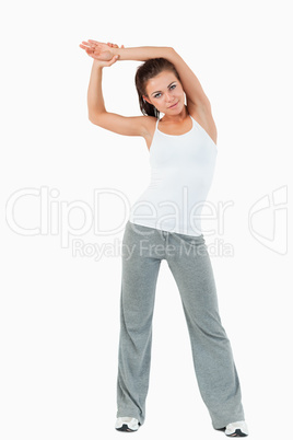 Portrait of a sports woman stretching her arms