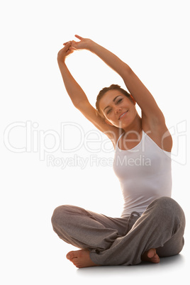 Portrait of a young woman stretching her back