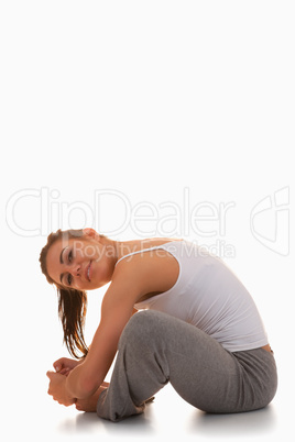 Portrait of a young woman stretching her legs