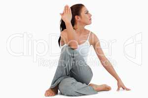 Portrait of a fit woman in the Ardha Matsyendrasana position
