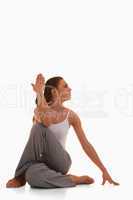 Portrait of a young woman in the Ardha Matsyendrasana position