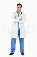 Portrait of a doctor standing up with the arms crossed